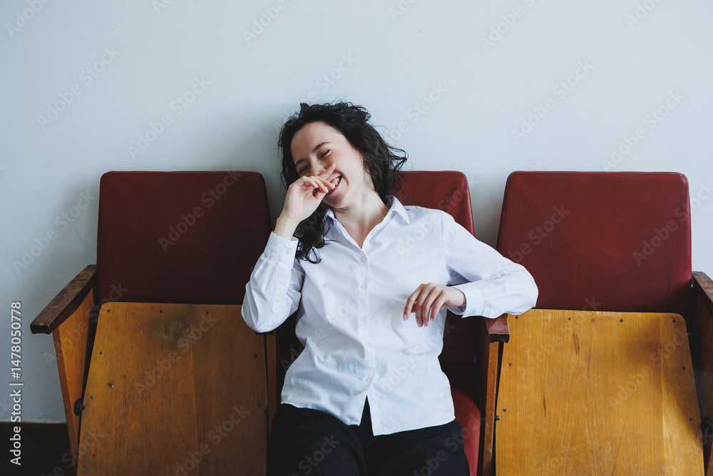 A joyful woman relaxes on stunning vintage chairs that enhance a modern setting, creating a stylish atmosphere that invites everyone to savor the experience together, promoting connection and warmth