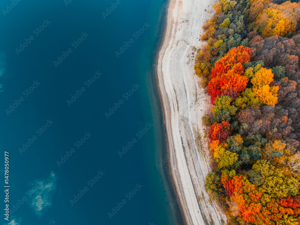 Liptov region with Tatras mountains around. Liptovska mara dam landspace. autumn deciduous forest view from above