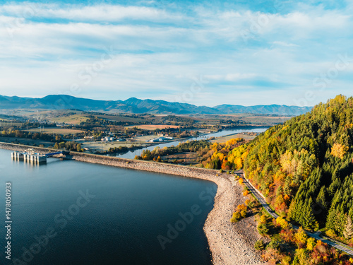 Liptov region with Tatras mountains around. Liptovska mara dam landspace. Autumn deciduous forest view from above
