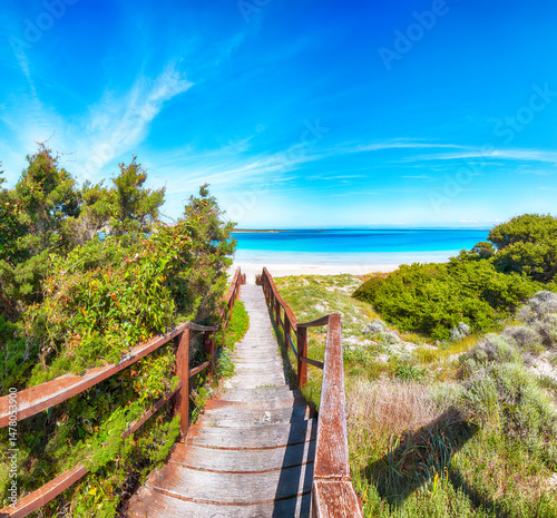 Unbelivable view of Famous La Pelosa beach (Spiaggia della Pelosa) with wooden footbridge.