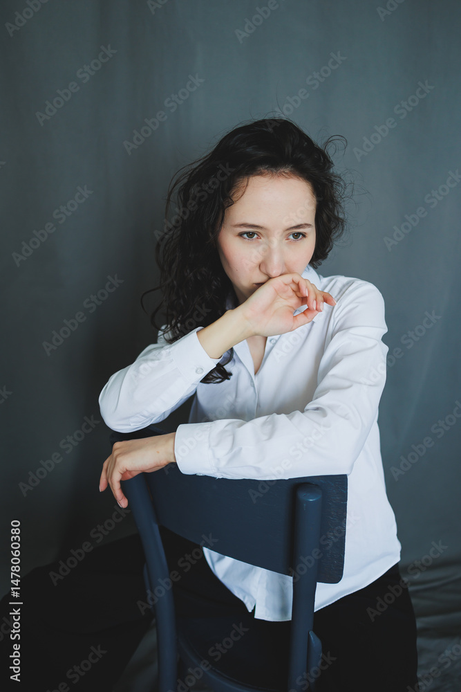 This captivating portrait shows a thoughtful woman in stylish attire, capturing her profound reflection and emotions, representing deep inner contemplation with grace and authenticity