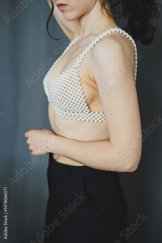 The PearlEmbellished Bra paired with Black Trousers forms an Elegant Fashion Statement, embodying creativity and boldness in a chic ensemble that inspires confidence and individuality