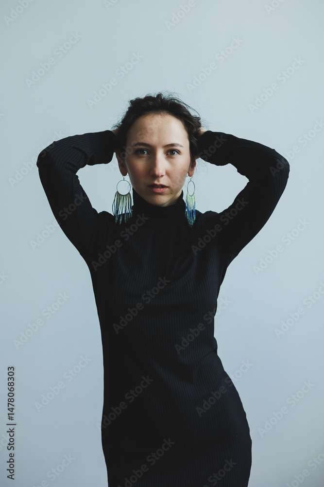 An Elegant Model Posing Gracefully Against a Minimalist Background, Showcasing Striking Earrings That Highlight Her Beauty and Style, Exuding Confidence and a Classy Attitude in Every Frame