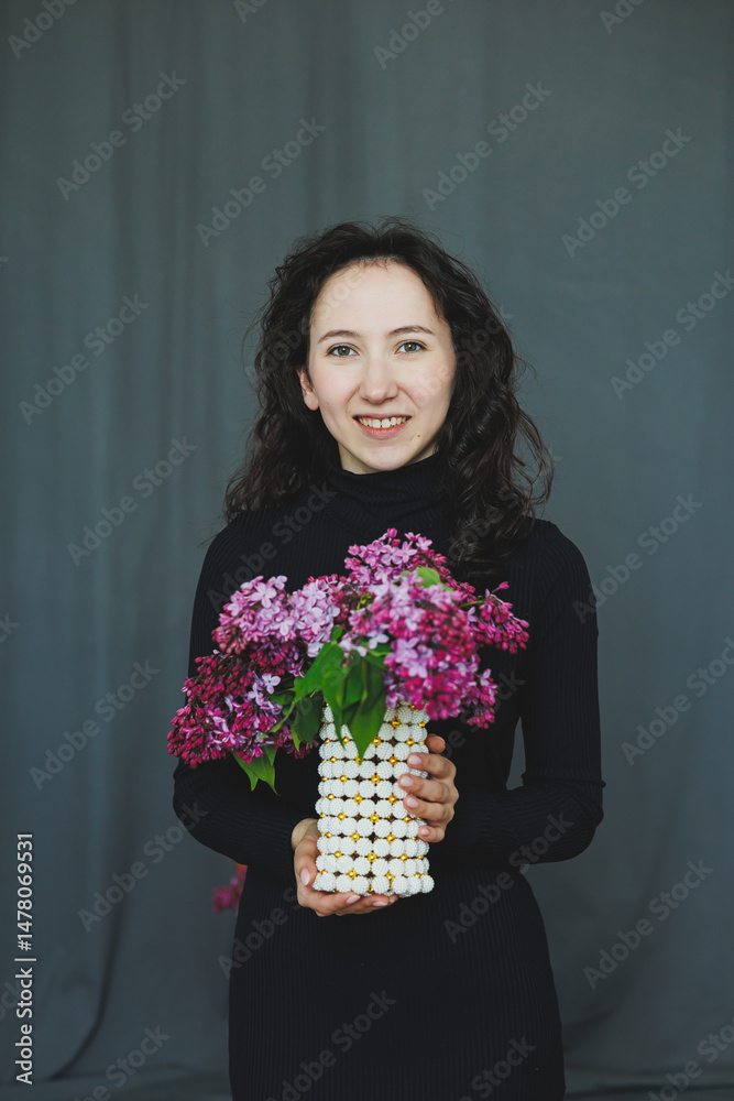 A Cheerful Woman Holding a Beautiful Bouquet of Vibrant and Colorful Flowers in a Simplistic, Minimalist Studio Setting That Evokes a Sense of Joy and Serenity in Nature and Beauty