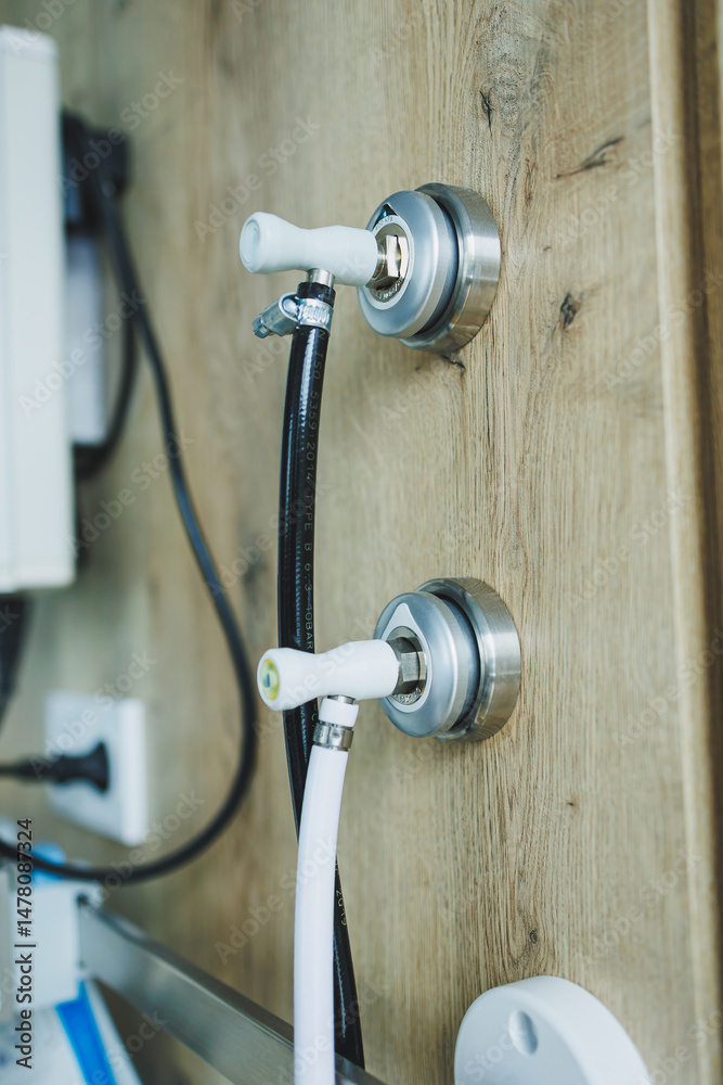 Discover stylish water connection fixtures that are elegantly mounted on a wooden wall, making them the perfect choice for enhancing modern interior design aesthetics in any contemporary space