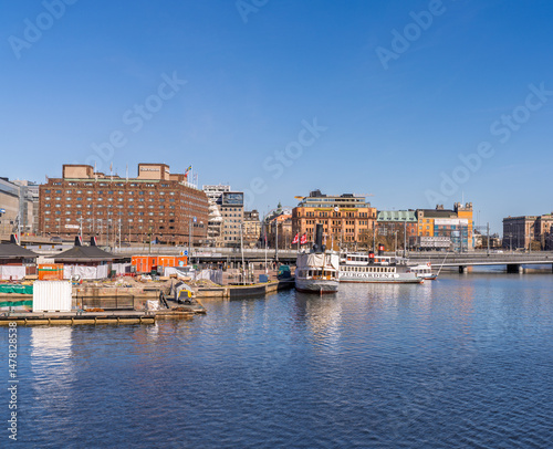 Photography Historic waterfront with ferries and city buildings in Stockholm