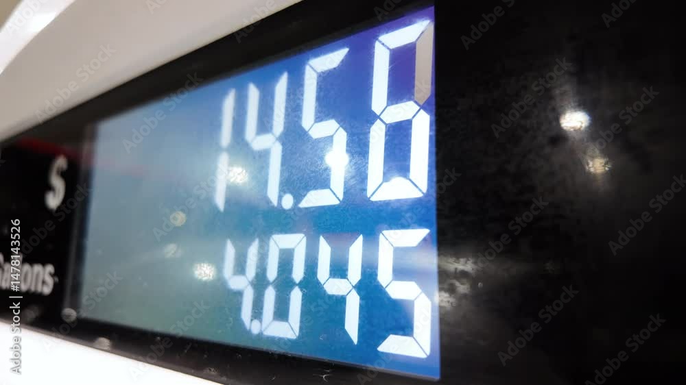 Petrol station with running numbers on gas pump at night time. Close up 