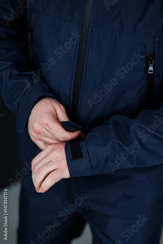 Obraz na płótnie This Stylish Navy Outdoor Jacket comes equipped with Adjustable Cuffs, making it the perfect choice for those who lead Active Lifestyles and enjoy participating in various outdoor activities w salonie