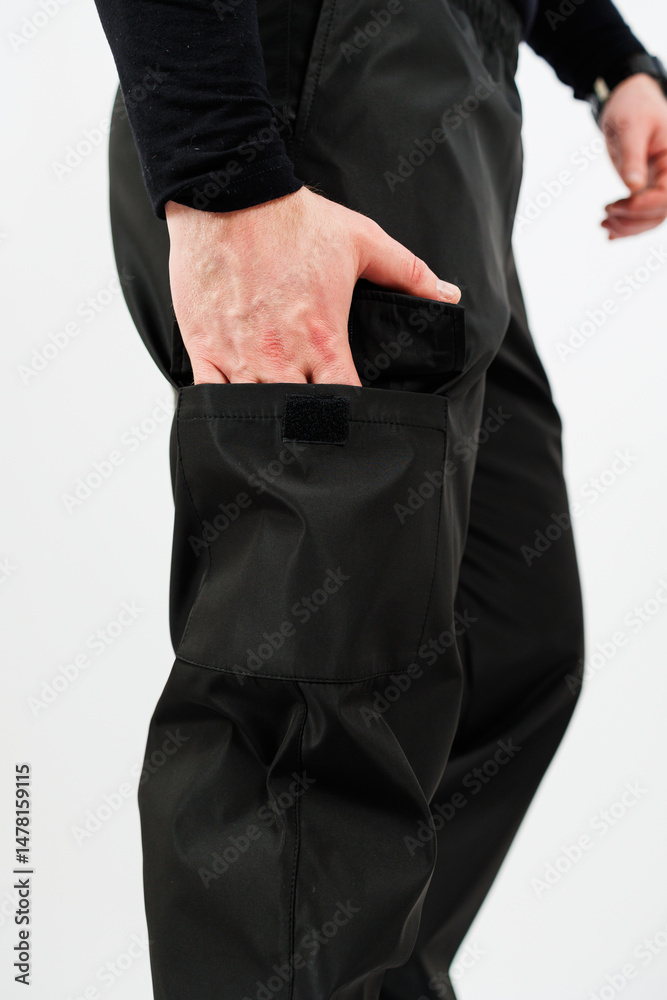 A closeup view of incredibly stylish black cargo pants showcasing their functional pocket detail, designed perfectly for both fashionable looks and utility in activewear situations