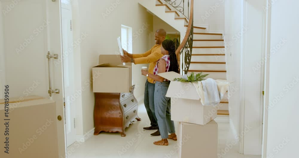 Happy black woman and man embracing holding take away drinks by cardboard boxes, moving into new hom