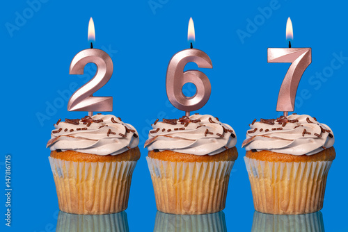 Birthday Cupcakes With Candles Lit Forming The Number 267.