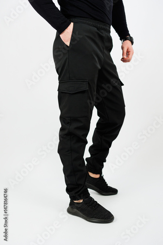 Obraz na płótnie Discover the Stylish Black Cargo Pants that are perfect for an Active Lifestyle. These pants are versatile, offering comfort and functionality, making them ideal activewear for men who value fashion w salonie