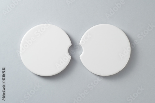 Two car cup holder coasters. Top view of ceramic coaters on isolated background. Blank coasters mockup