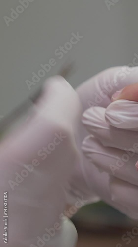 Manicure process for male nails in a beauty salon close up. Professional manicurist in gloves cut the cuticle with a nippers. Concept spa body care for man
