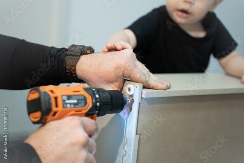 Wallpaper Mural dad and son doing renovations together assembling a wardrobe  electric drill construction furniture assembly cabinet assembly furniture assembly instructions  Torontodigital.ca