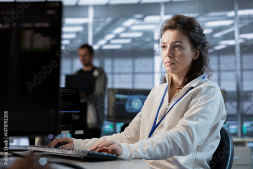 Wallpaper Mural Data center programmer writing disaster recovery plans ensuring minimal downtime. Woman in server farm workplace uses analytics to monitor performance and predict future infrastructure needs Torontodigital.ca