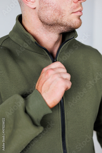 Obraz na płótnie The Stylish Male Model is captured beautifully in an olive green zipup jacket, posing effortlessly for an exciting fashion shoot that highlights his striking features and dynamic style w salonie