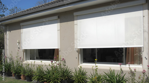 External roller blinds installed on modern windows, providing enhanced sun protection for house exteriors