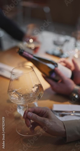 Champagne tasting, Wine glasses are on the table, stylish table setting, A man's hand holds a beautiful elegant glass with rose sparkling wine, an intimate light, a plate with oysters and lemon