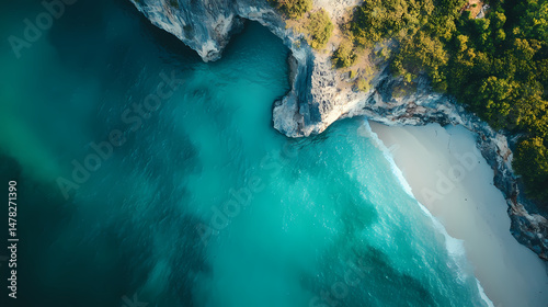 Seashore Serenity: A breathtaking aerial perspective captures the unspoiled beauty of a turquoise sea meeting a pristine beach and rugged cliffside.