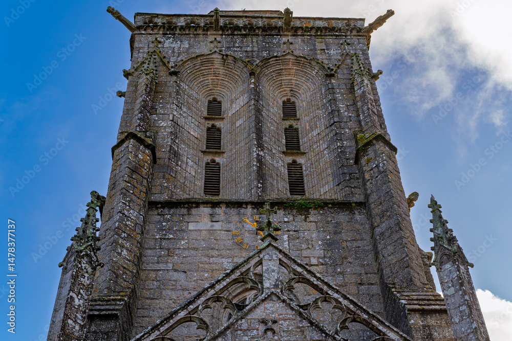 Fototapeta premium Detailed view of the bell tower of Locronan Cathedral. Photography taken in Locronan, French Brittany, France.