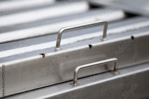 rusty metal ladder on a gray background, closeup of photo