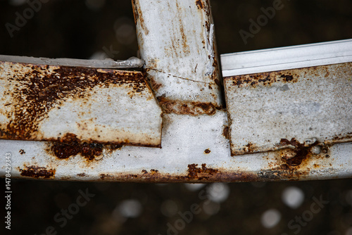 rusty metal ladder on a gray background, closeup of photo