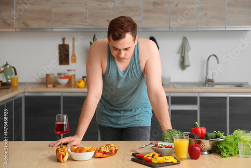 Young sad overweight man ch...
