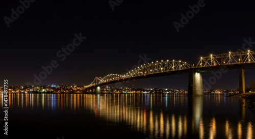 Night view of bridge over water photo