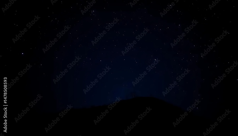 Naklejka premium Astrophotography showing a dark silhouette mountain range under a starry night sky