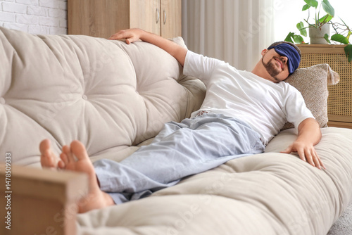 Young happy man in pajamas ...