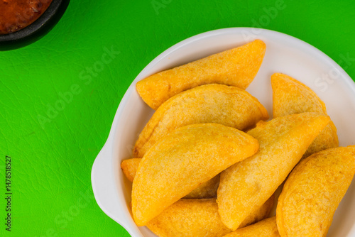 Colombian empanada with spicy sauce 