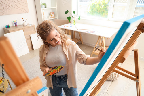 Female artist with brush an...