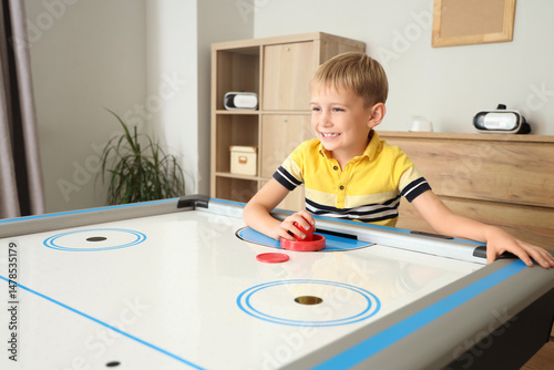 Little boy playing air hock...