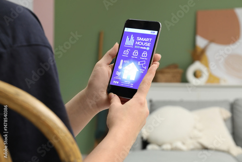 Young woman using smart hom...