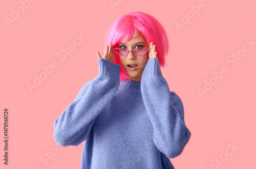 Shocked young woman in pink...