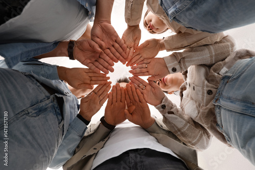 Group of people putting han...