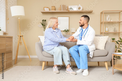 Male doctor with mature wom...