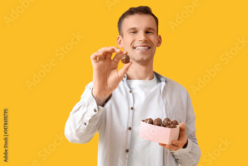 Smiling young man holding a...