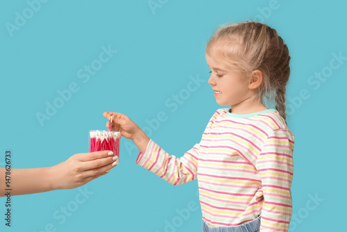 Cute little girl taking cot...