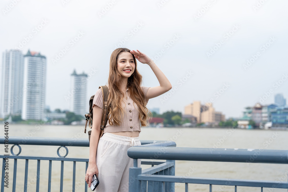 Asian young beautiful woman backpacker exploring the city outdoors. Asian young beautiful woman backpacker exploring the city outdoors.