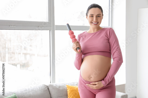 Prenatal wellness and pregnancy self care, smiling pregnant woman using a mas...