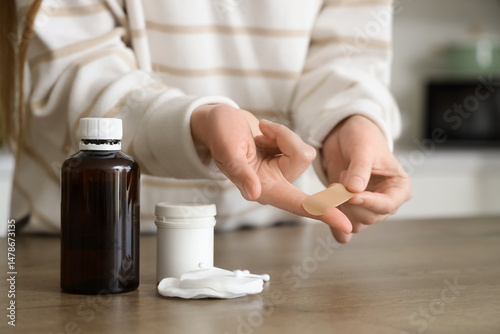 Young woman applying medica...