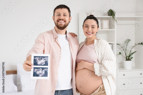 Happy pregnant couple with ...