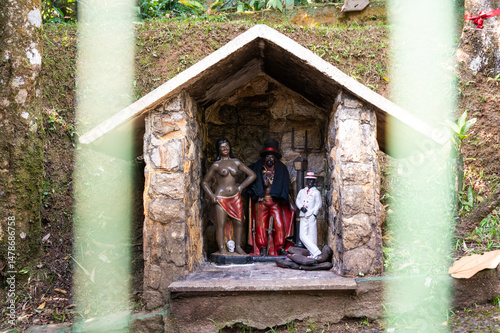 stone house statue exu pomba gira ze pilintra