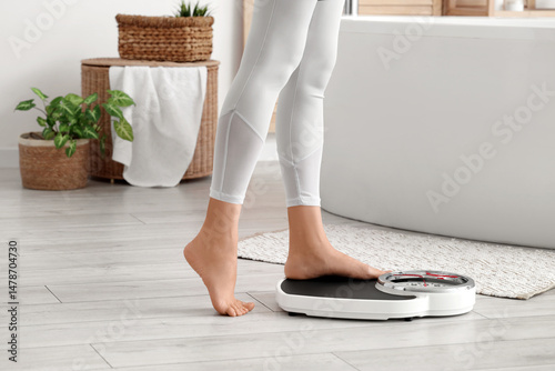 Legs of sporty woman measur...