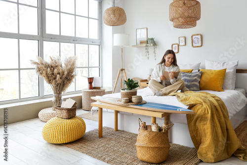 Young woman reading book wi...