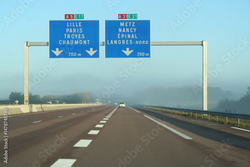 motorway signs in France above a misty freeway - panneaux autoroutiers en France au dessus d'une autoroute embrummée