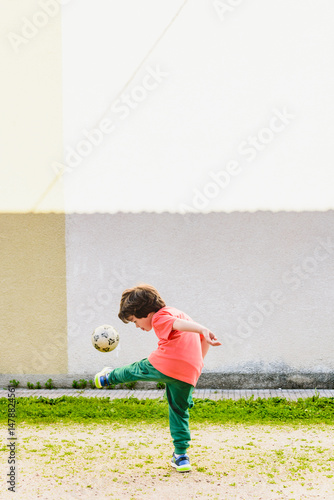 Young boy practices soccer skills on a sunny day