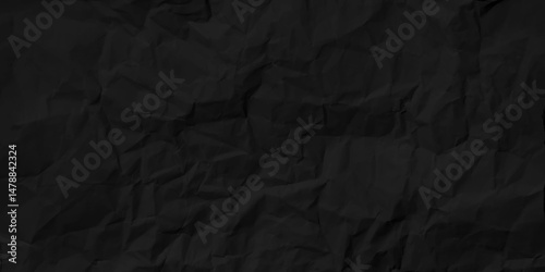 Closeup of black crumpled paper for texture background. Sheet of printer paper wrinkled background.